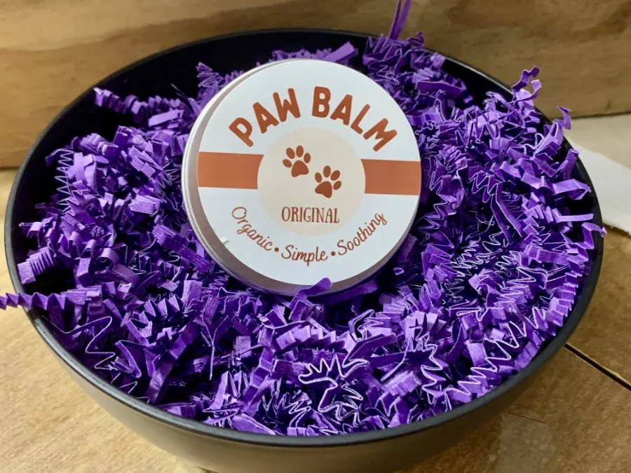 Person using a pen to cross a task off a productivity paper card.